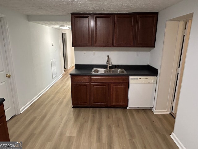 kitchen featuring a textured ceiling, wood-type flooring, sink, and white dishwasher