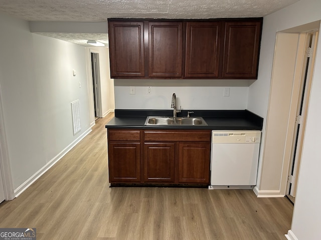 kitchen featuring white dishwasher, light hardwood / wood-style flooring, sink, and a textured ceiling