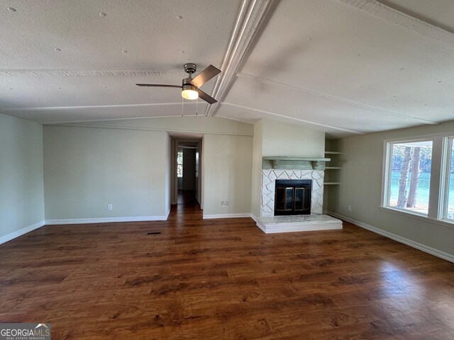 unfurnished living room featuring lofted ceiling with beams, ceiling fan, a textured ceiling, and dark hardwood / wood-style flooring