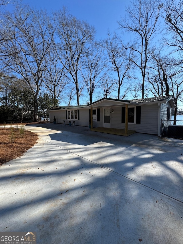 ranch-style house with concrete driveway