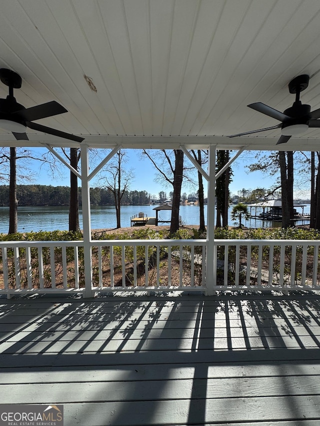 deck featuring a water view and a ceiling fan