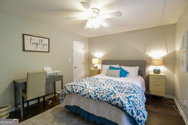 bedroom with a textured ceiling, dark wood-type flooring, and ceiling fan