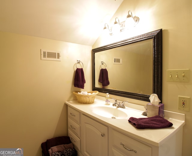 bathroom featuring vanity and vaulted ceiling