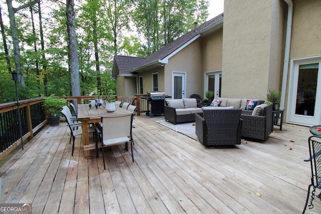 wooden deck with an outdoor living space and a grill