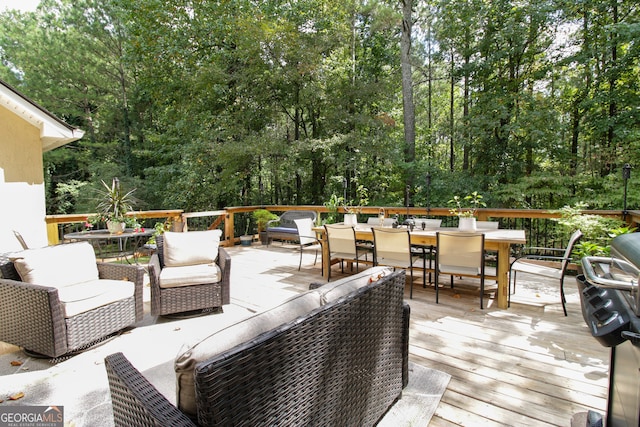 wooden deck with an outdoor living space and a grill