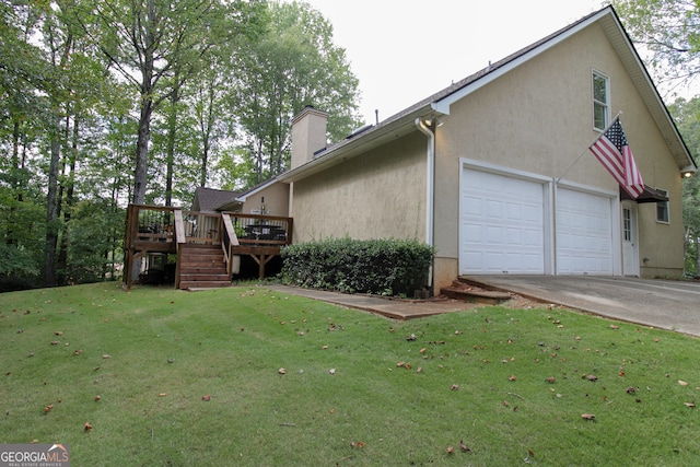 view of side of home featuring a lawn, a deck, and a garage