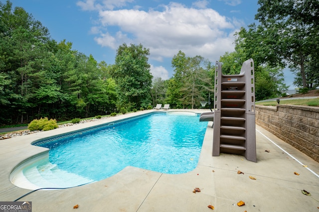 view of swimming pool with a patio area