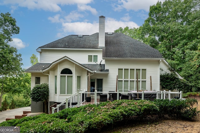 rear view of property with a wooden deck