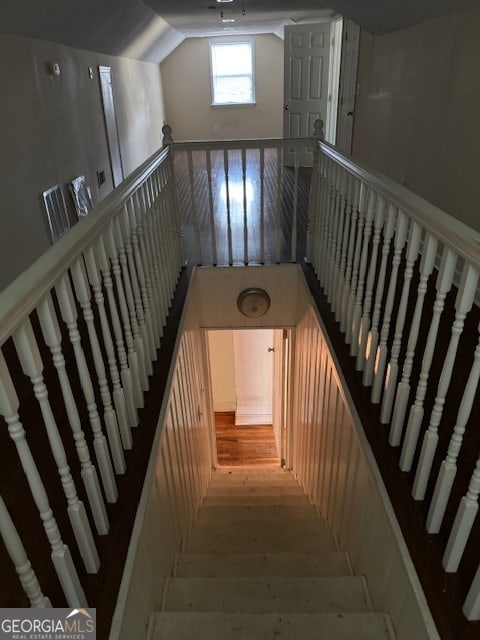 staircase with hardwood / wood-style floors