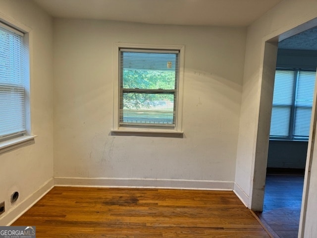 unfurnished room with dark hardwood / wood-style flooring