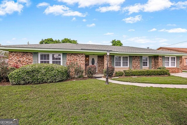 ranch-style home with a front lawn