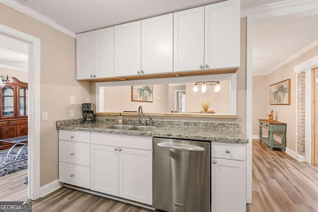 kitchen with stainless steel dishwasher, white cabinetry, sink, and light hardwood / wood-style flooring