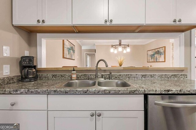 kitchen featuring white cabinetry, dishwasher, and sink