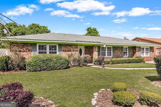 ranch-style home featuring a front yard