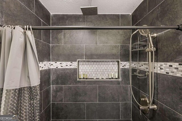 bathroom featuring a textured ceiling and a shower with shower curtain