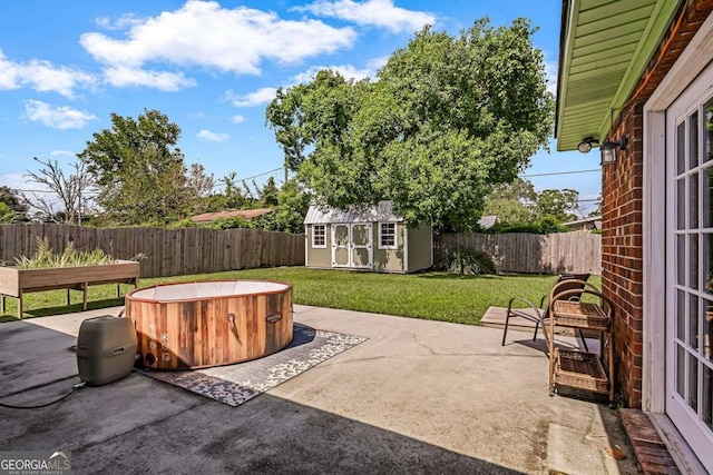 view of patio with a storage shed and a hot tub