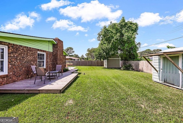 view of yard featuring a storage shed and a deck