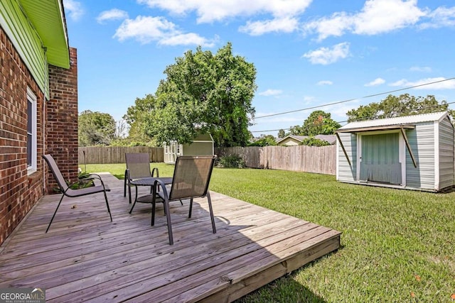 deck featuring a storage unit and a lawn