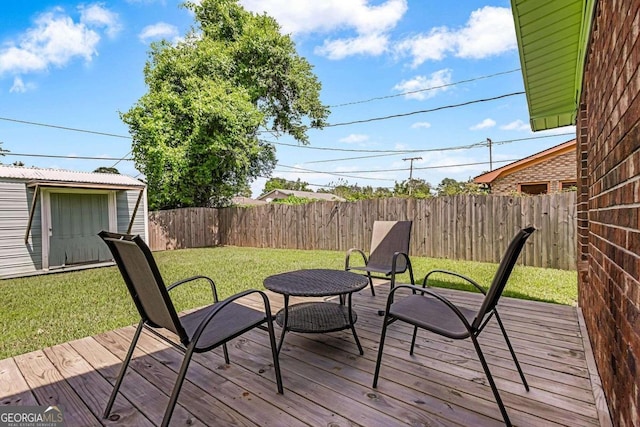 wooden terrace featuring a yard