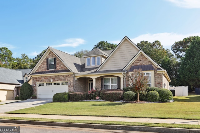 craftsman house featuring a front yard and a garage