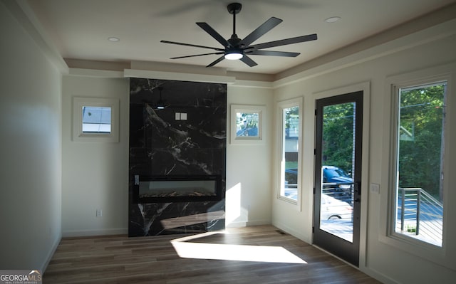 doorway to outside with ceiling fan and dark wood-type flooring