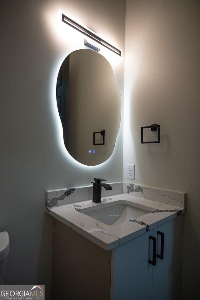 bathroom featuring vanity and toilet