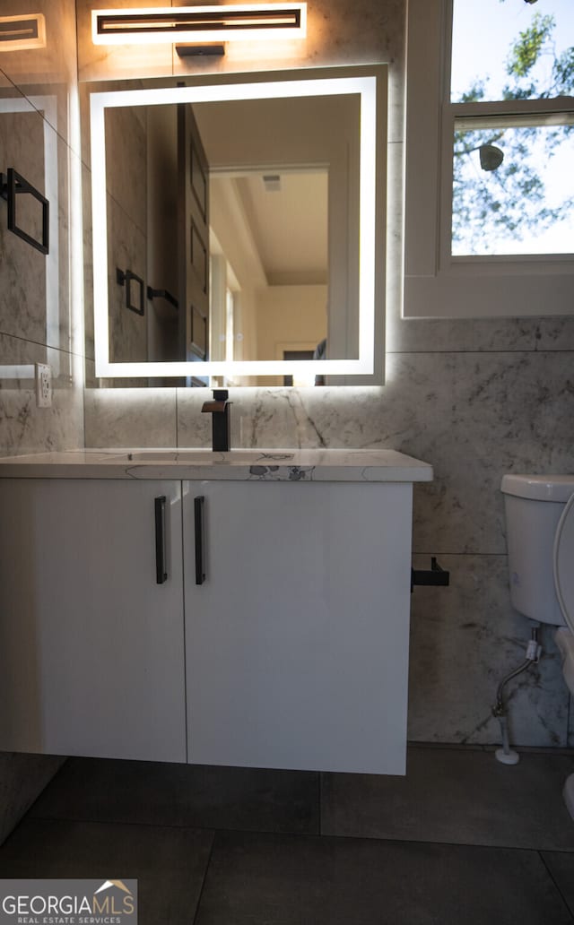 bathroom featuring vanity and toilet