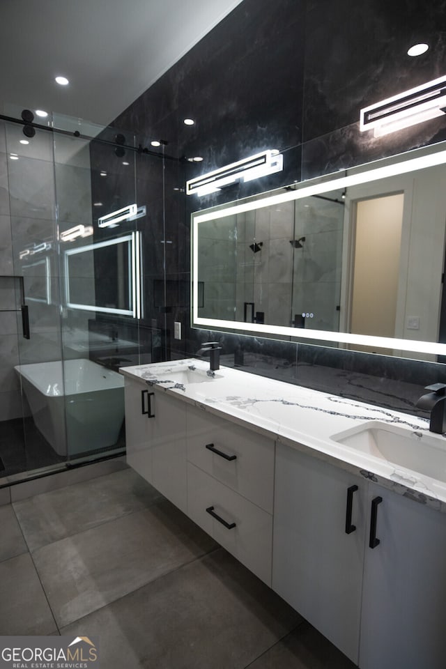 bathroom with vanity, a shower with shower door, and tile patterned floors