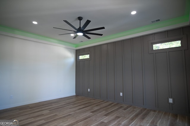 unfurnished room with ceiling fan and hardwood / wood-style flooring