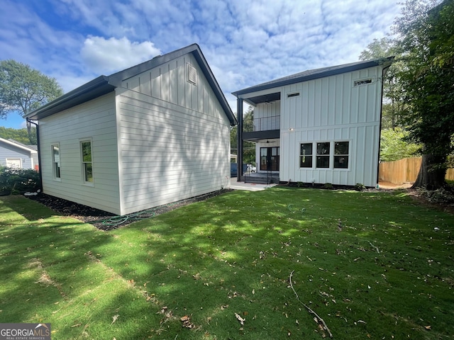 back of property featuring a lawn