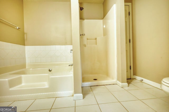 bathroom with shower with separate bathtub, tile patterned floors, and toilet