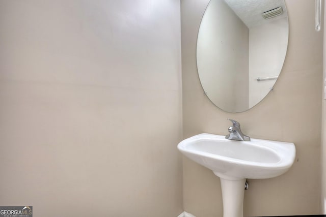 bathroom featuring tiled bath and tile patterned flooring