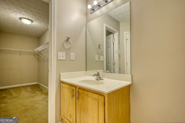 bathroom featuring a textured ceiling and vanity