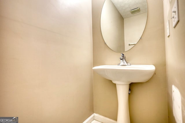 bathroom with a textured ceiling