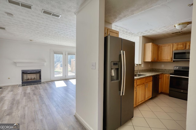 unfurnished living room with ceiling fan, hardwood / wood-style floors, and a textured ceiling