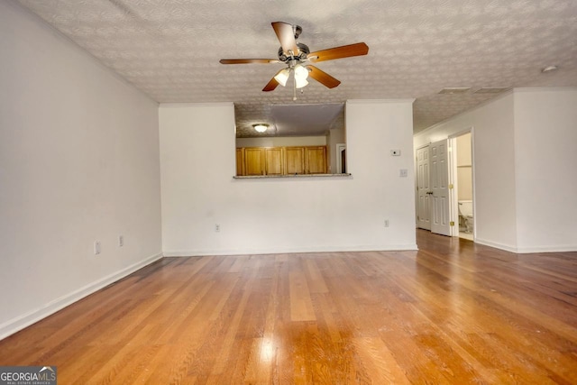 unfurnished living room featuring a textured ceiling, light wood-type flooring, and ceiling fan