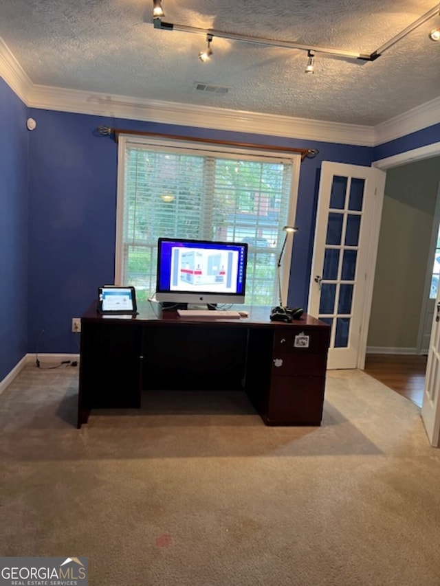 office with a textured ceiling, crown molding, and light carpet