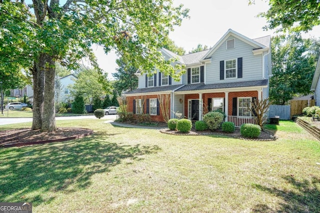 front facade with a front lawn and covered porch