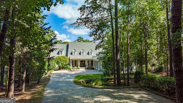 new england style home with covered porch