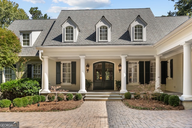 entrance to property with french doors and a porch