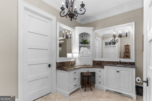 bathroom featuring a notable chandelier, vanity, and ornamental molding