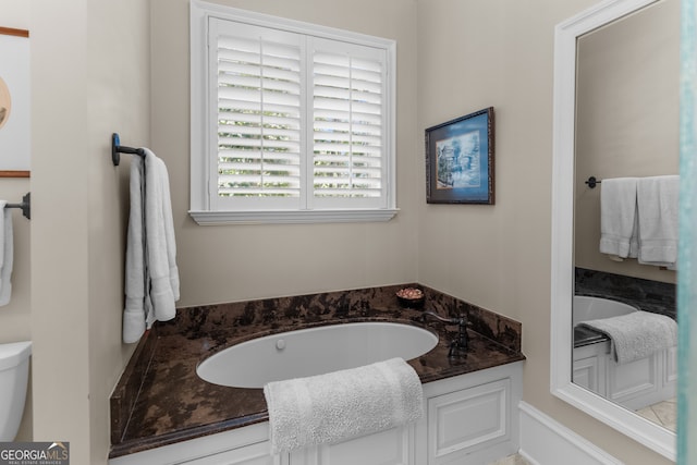 bathroom featuring a tub and toilet