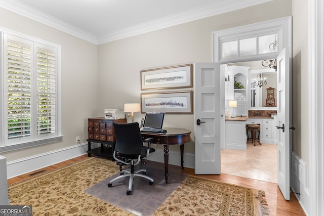 office with an inviting chandelier, light wood-type flooring, and ornamental molding