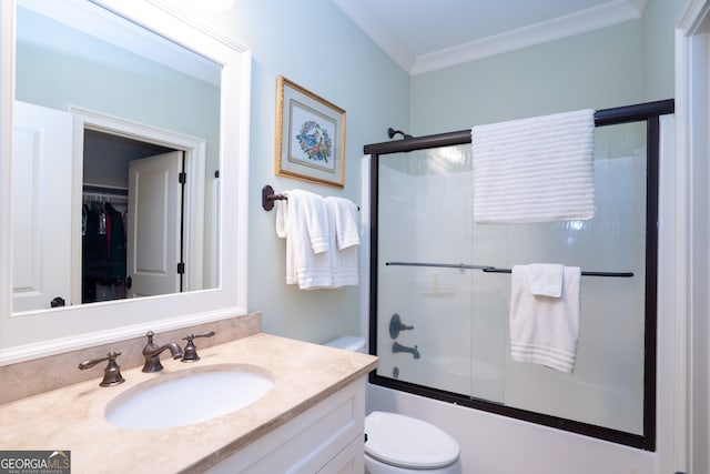 full bathroom featuring enclosed tub / shower combo, crown molding, vanity, and toilet