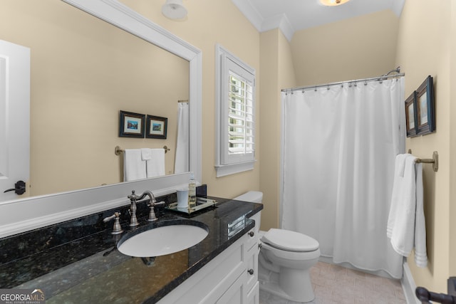 bathroom featuring ornamental molding, vanity, and toilet