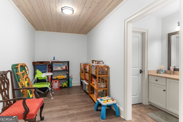 rec room with wood ceiling, light wood-type flooring, and crown molding