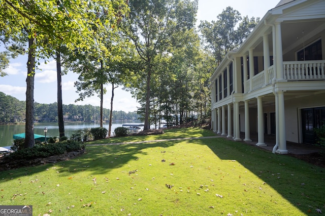 view of yard featuring a balcony and a water view