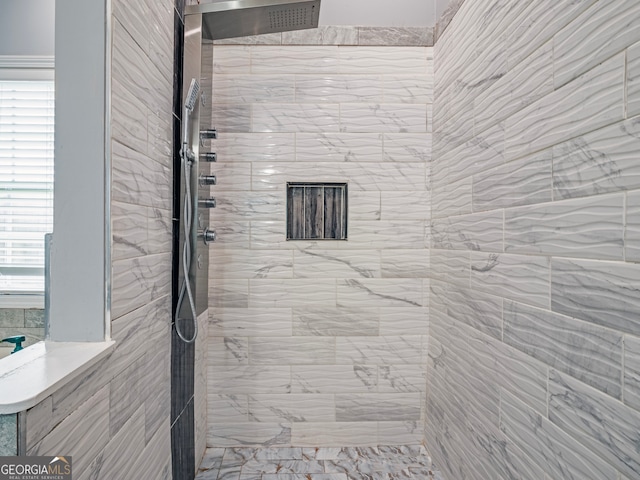 bathroom with a tile shower