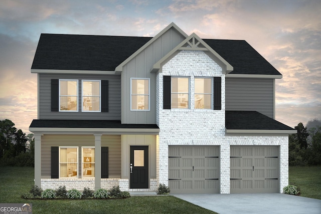 view of front of home featuring a lawn and a garage