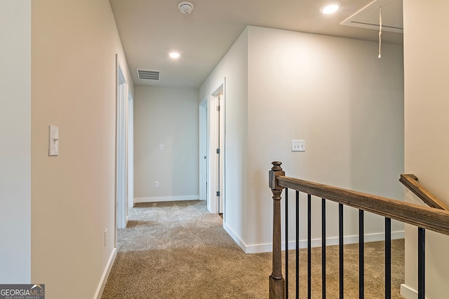 corridor with light colored carpet